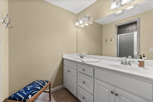 a bathroom with a double vanity sink and a mirror