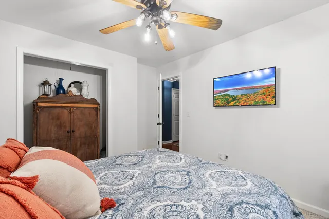 a bedroom with a bed and a painting on the wall