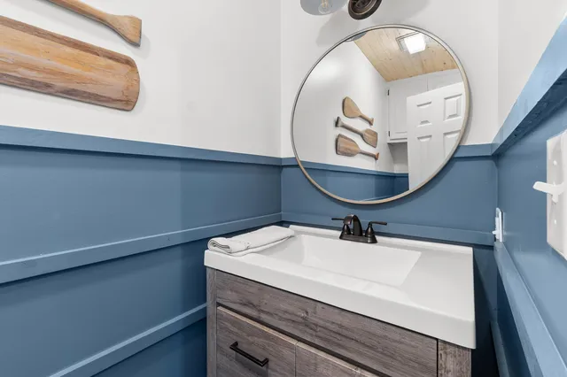 a bathroom with a sink a mirror and bathtub