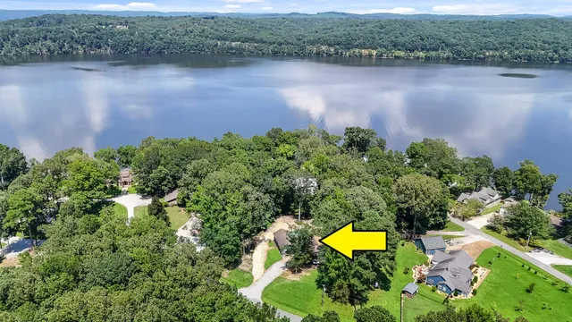 an aerial view of a house with a lake view