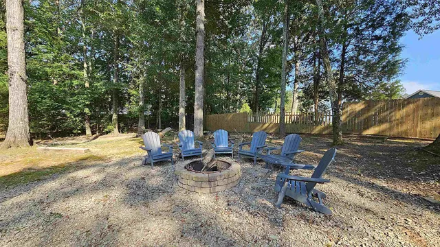 a view of a lake with chairs and table