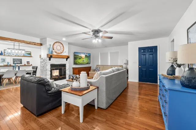 a living room with fireplace furniture and a wooden floor