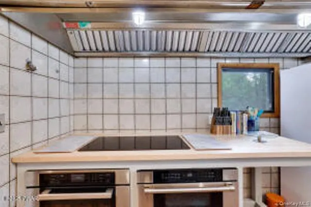 a kitchen with a sink a stove and cabinets