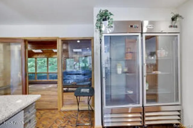 a bathroom with a glass shower door and a window