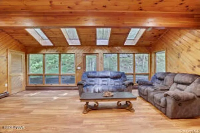 a living room with furniture and large windows
