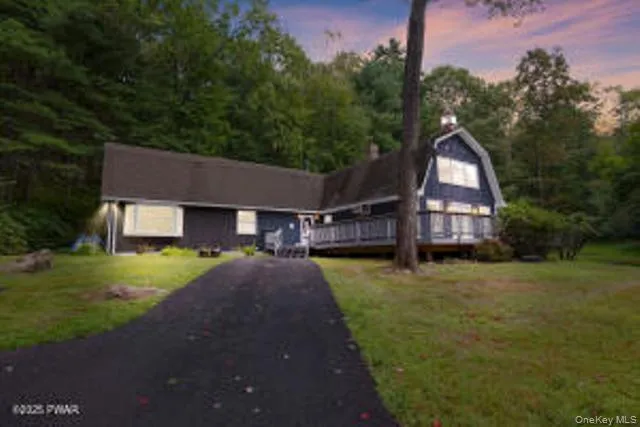 a front view of a house with a yard and trees