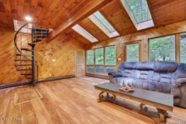 a living room with furniture and a floor to ceiling window