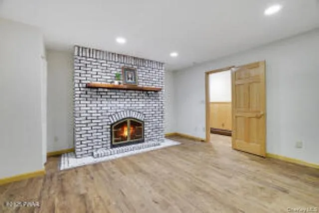 a view of empty room with a fireplace