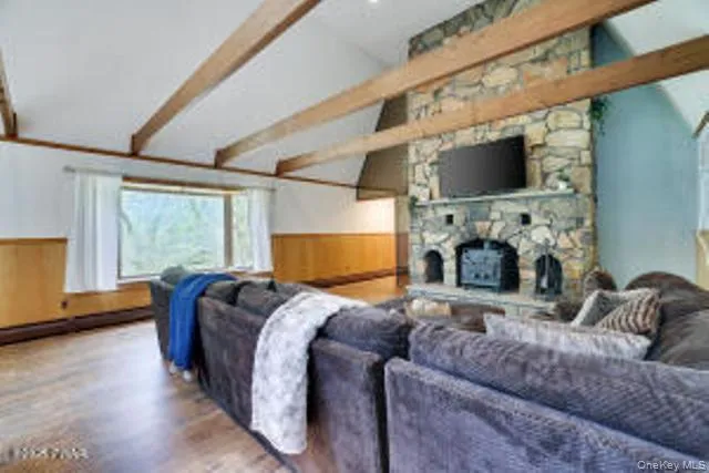 a bed room with furniture and a flat screen tv