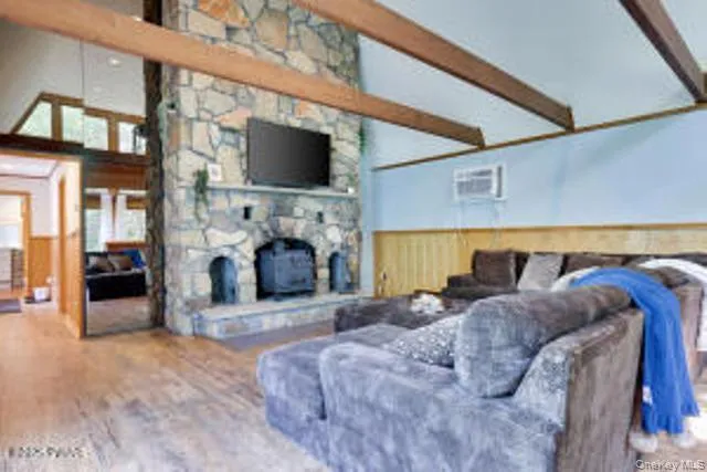 a living room with furniture a flat screen tv and a fireplace