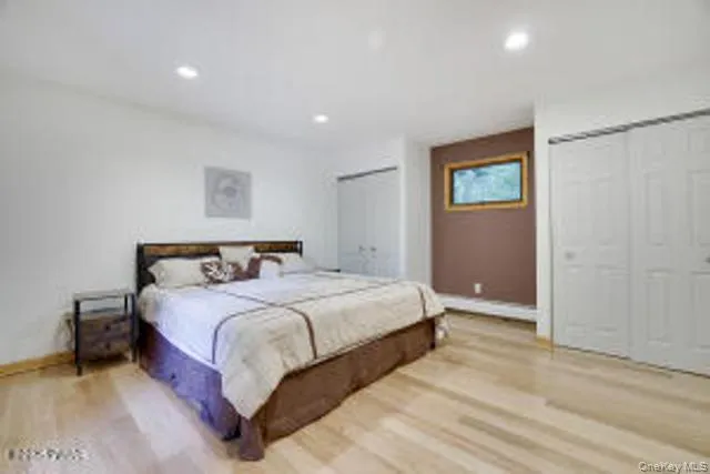 a bedroom with a bed and a painting