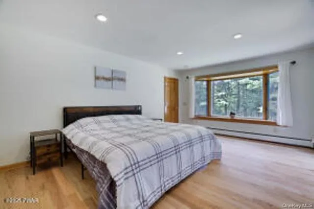 a bedroom with a bed and a large window