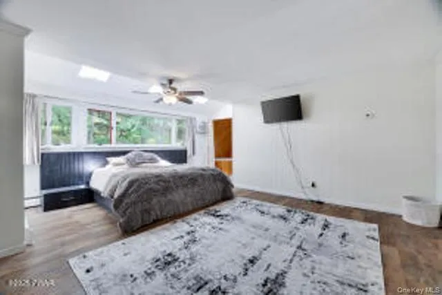 a bedroom with a bed and a potted plant