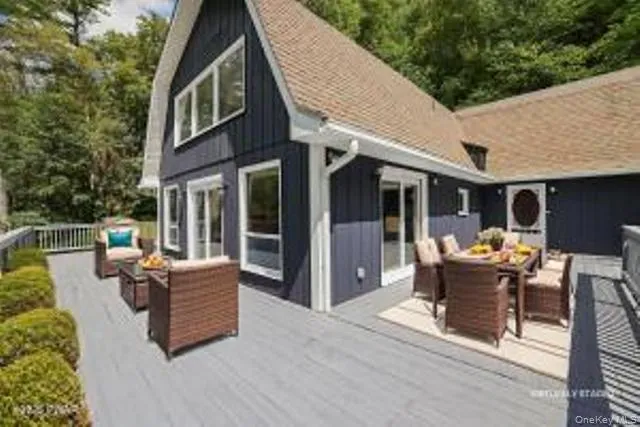 a view of a patio with couches table and chairs and potted plants