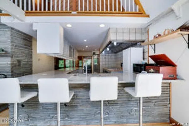 a kitchen with a table chairs and a living room