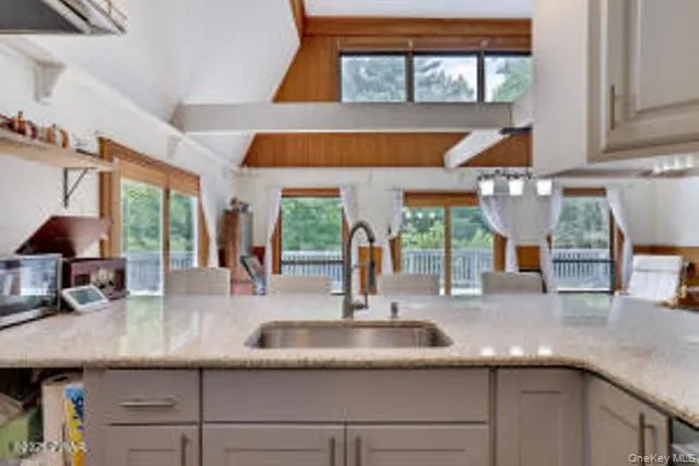 a kitchen with a sink and a large window