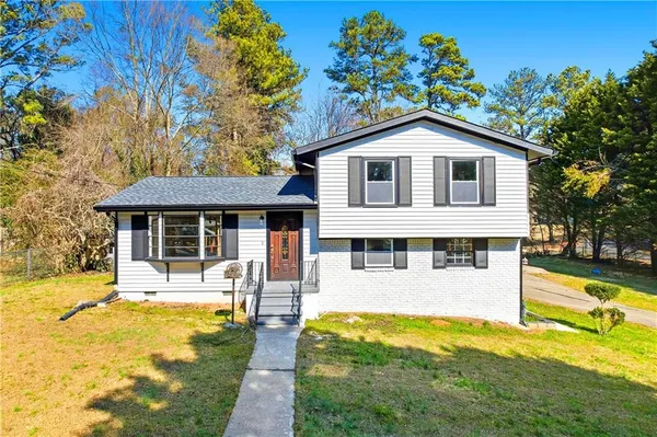 a front view of a house with a yard