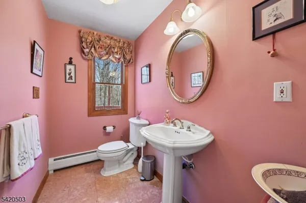 a view of a hallway with wooden floor and windows