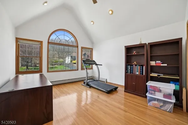 a view of a big house with a big yard and large trees
