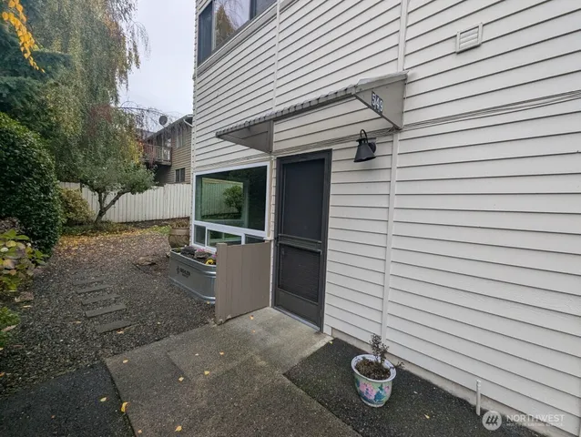 a view of a patio with table and chairs and potted plants
