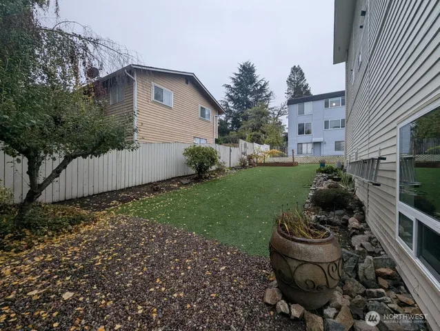 a view of backyard of house with outdoor seating