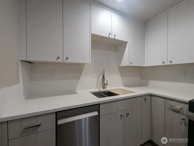 a kitchen with a sink and cabinets