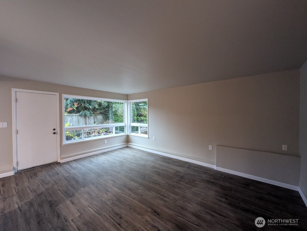 549 Elm Way Edmonds, WA 98020 - Photo 6 of 13 a view of a big room with wooden floor and windows