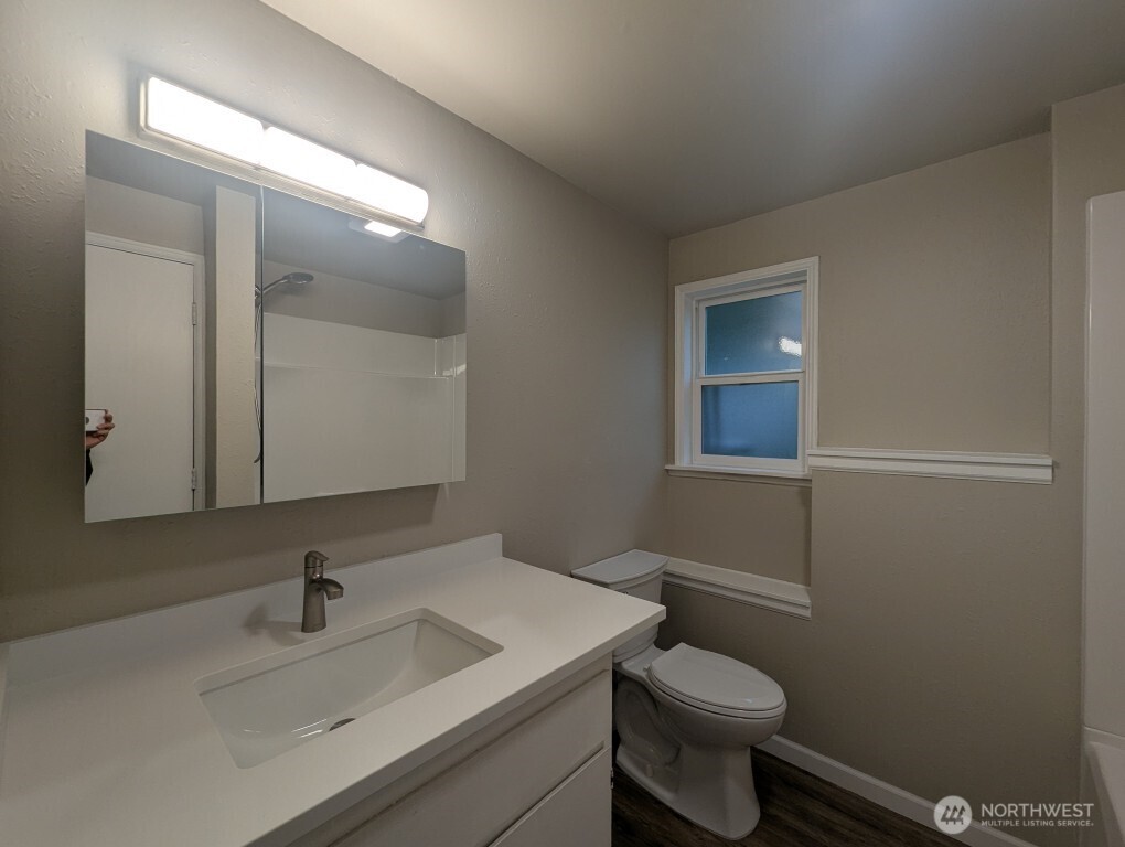 549 Elm Way Edmonds, WA 98020 - Photo 8 of 13 a bathroom with a sink toilet and mirror