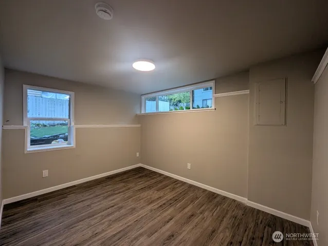 a view of room with window and hardwood floor