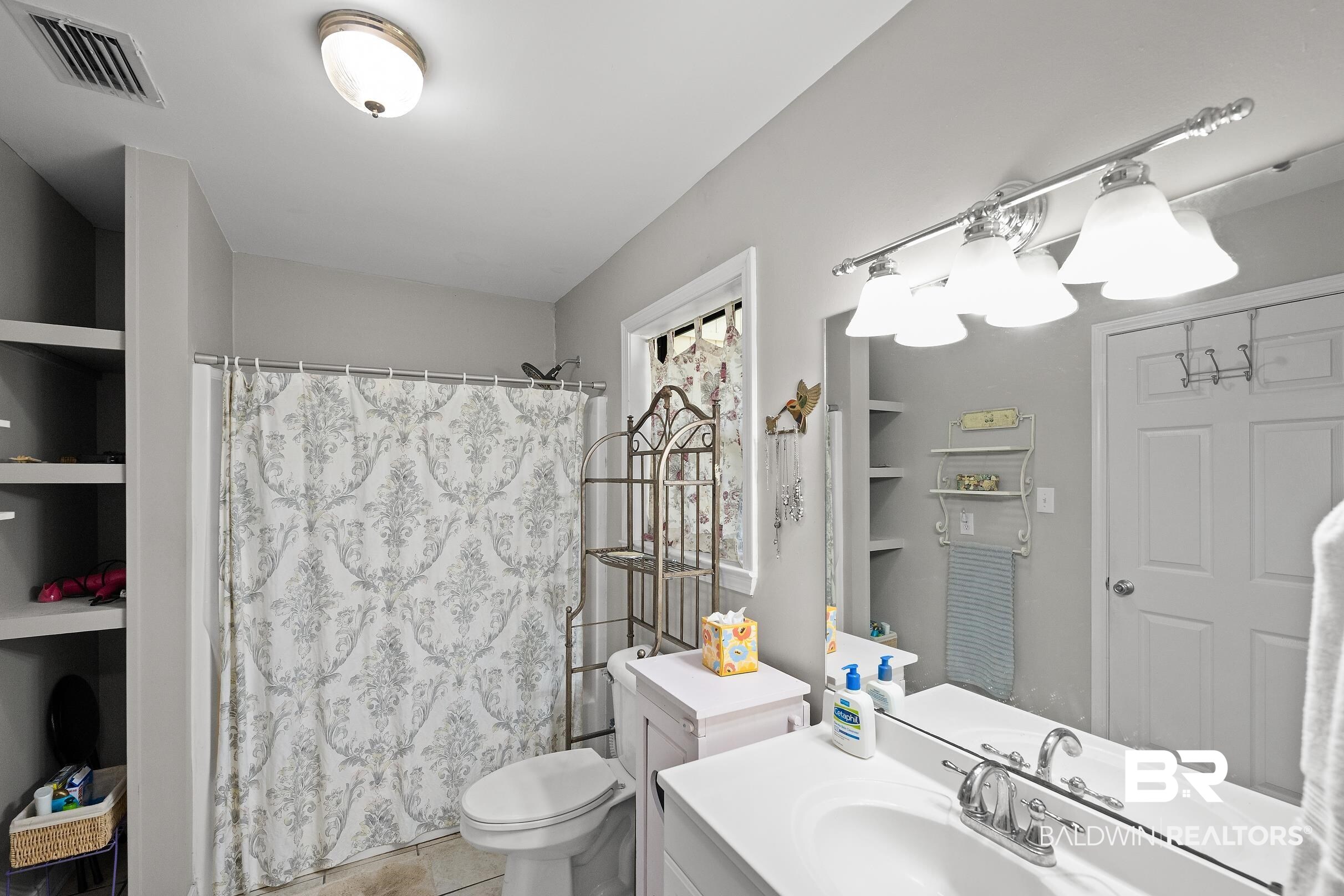 4026 Kingsrow Row Mobile, AL 36619 - Photo 27 of 51 Bathroom with vanity, a shower with curtain, built in shelves, and light tile patterned floors