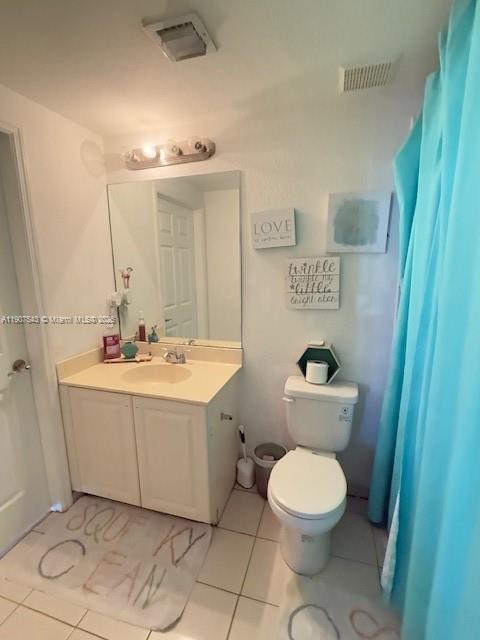 a bathroom with a sink mirror vanity and toilet