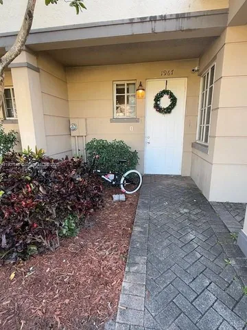 front view of a house with potted plants