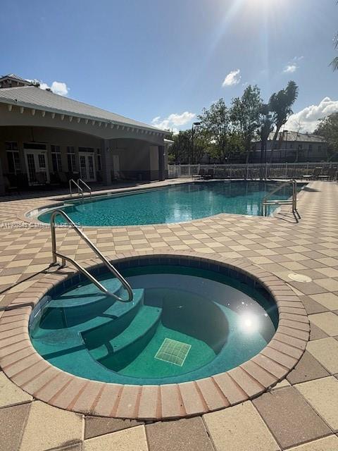 1967 Marsh Harbor Drive, Unit 313 Riviera Beach, FL 33404 - Photo 17 of 18 a view of a swimming pool with a yard
