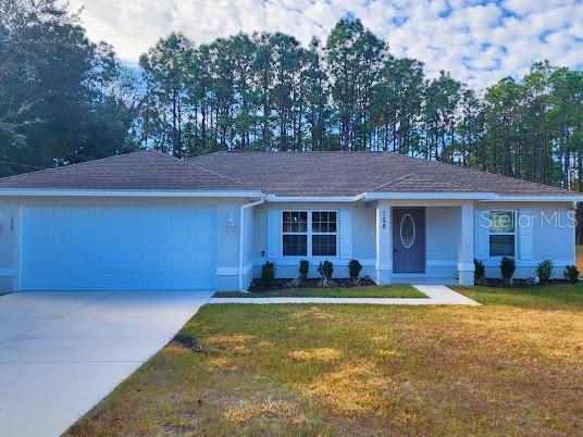128 Cedar Road Ocala, FL 34472 - Photo 1 of 1 a view of a yard in front of a house with large tree