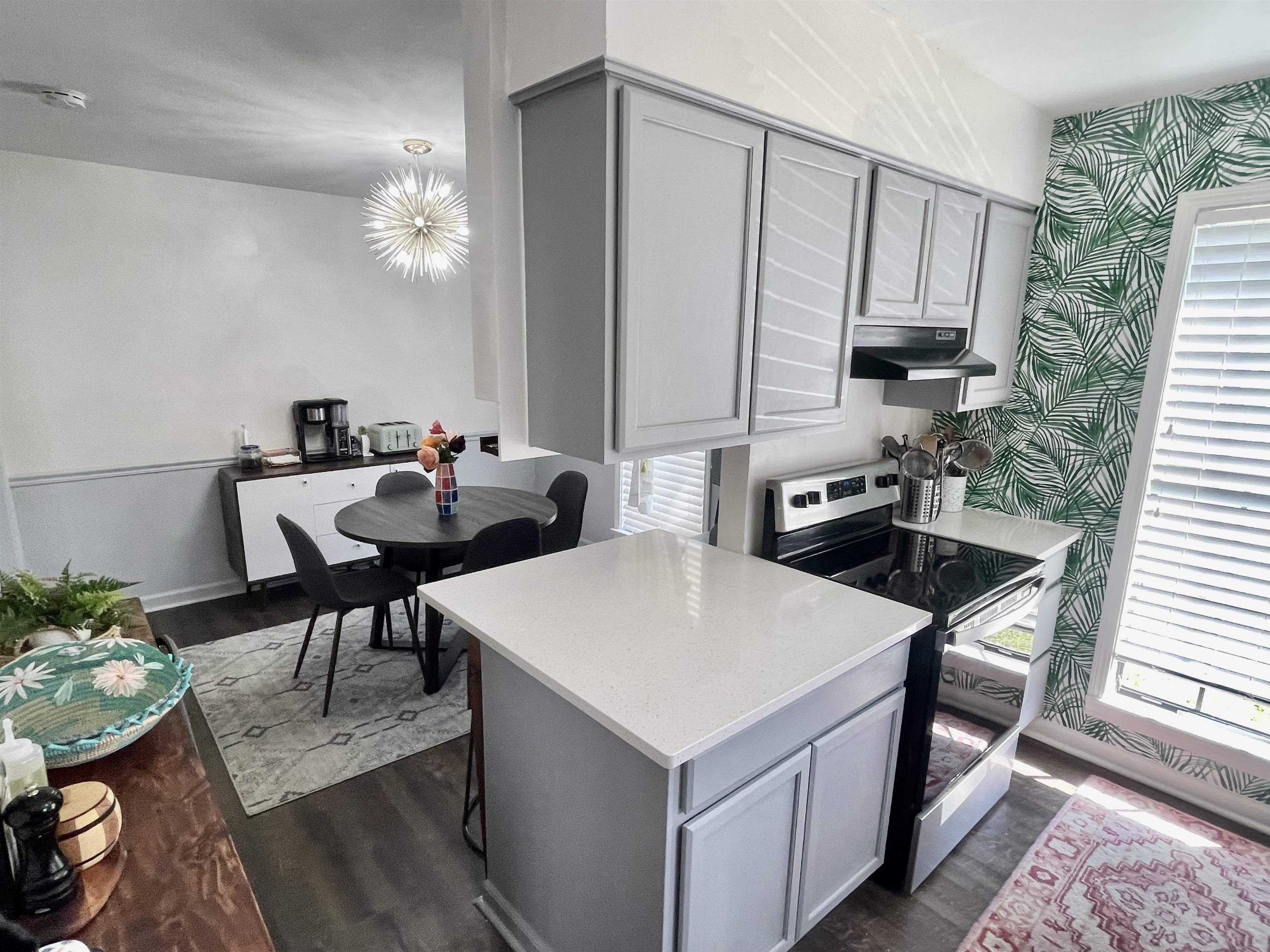 384 Fletcher Hollow Road Collierville, TN 38017 - Photo 10 of 17 a kitchen with a table chairs stove and microwave