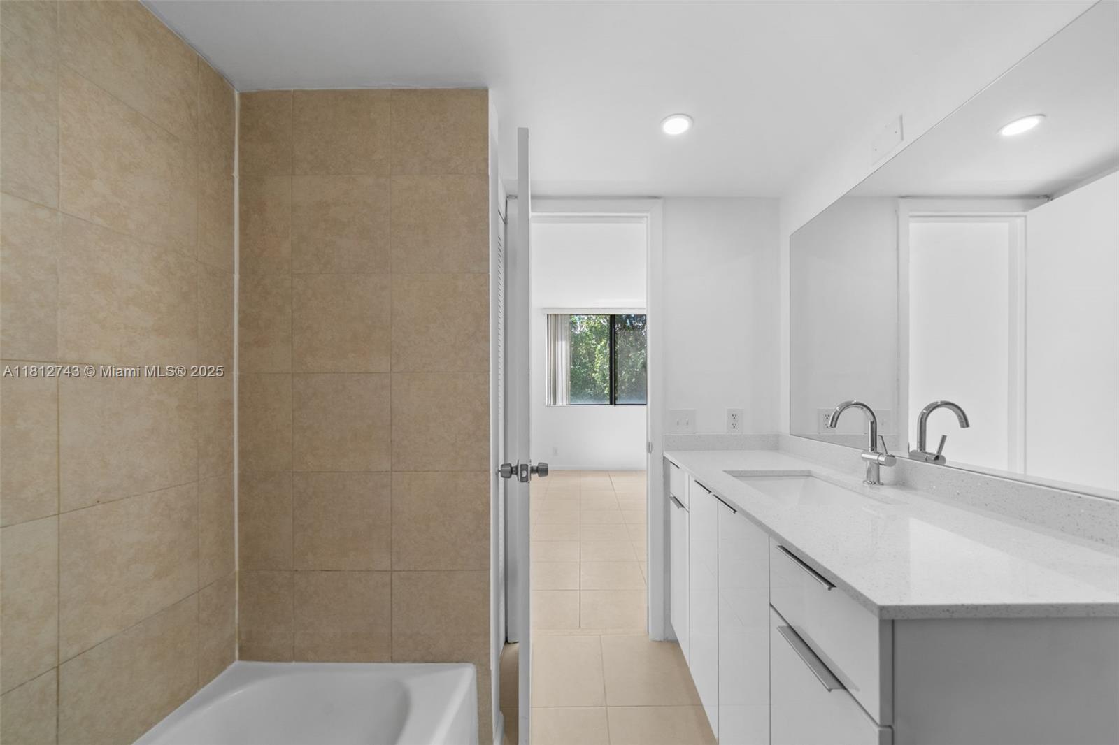 4222 Inverrary Boulevard, Unit 4211 Lauderhill, FL 33319 - Photo 11 of 18 a bathroom with a sink and a mirror