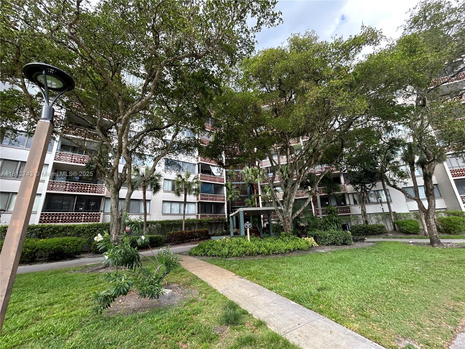4222 Inverrary Boulevard, Unit 4211 Lauderhill, FL 33319 - Photo 16 of 18 front view of a building with a yard