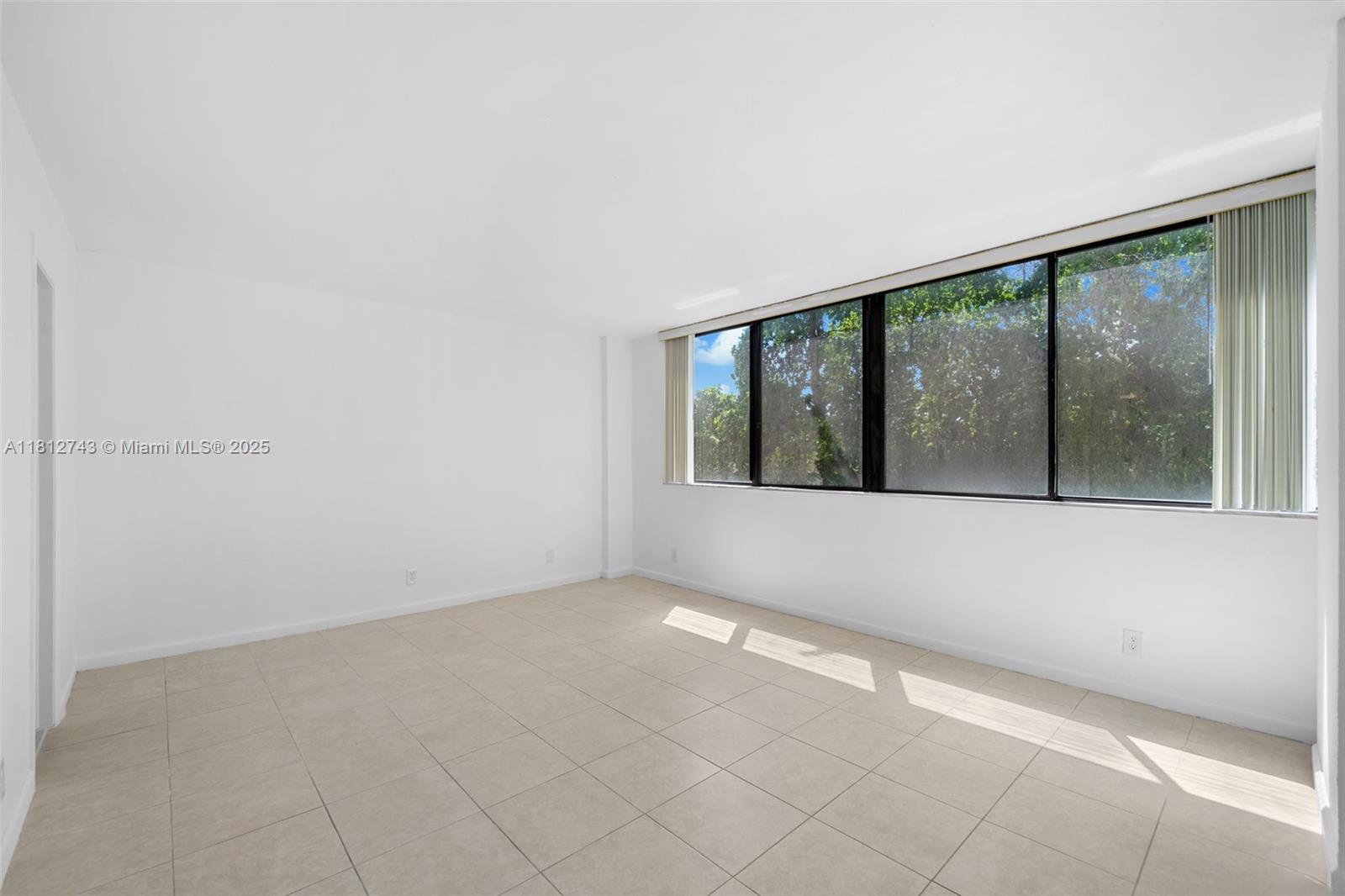 4222 Inverrary Boulevard, Unit 4211 Lauderhill, FL 33319 - Photo 6 of 18 an empty room with large windows