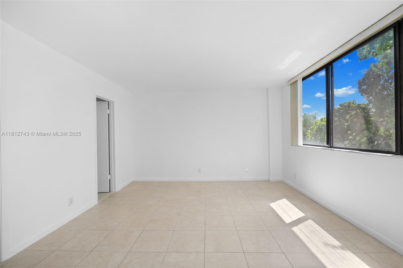 4222 Inverrary Boulevard, Unit 4211 Lauderhill, FL 33319 - Photo 7 of 18 a view of an empty room with a window