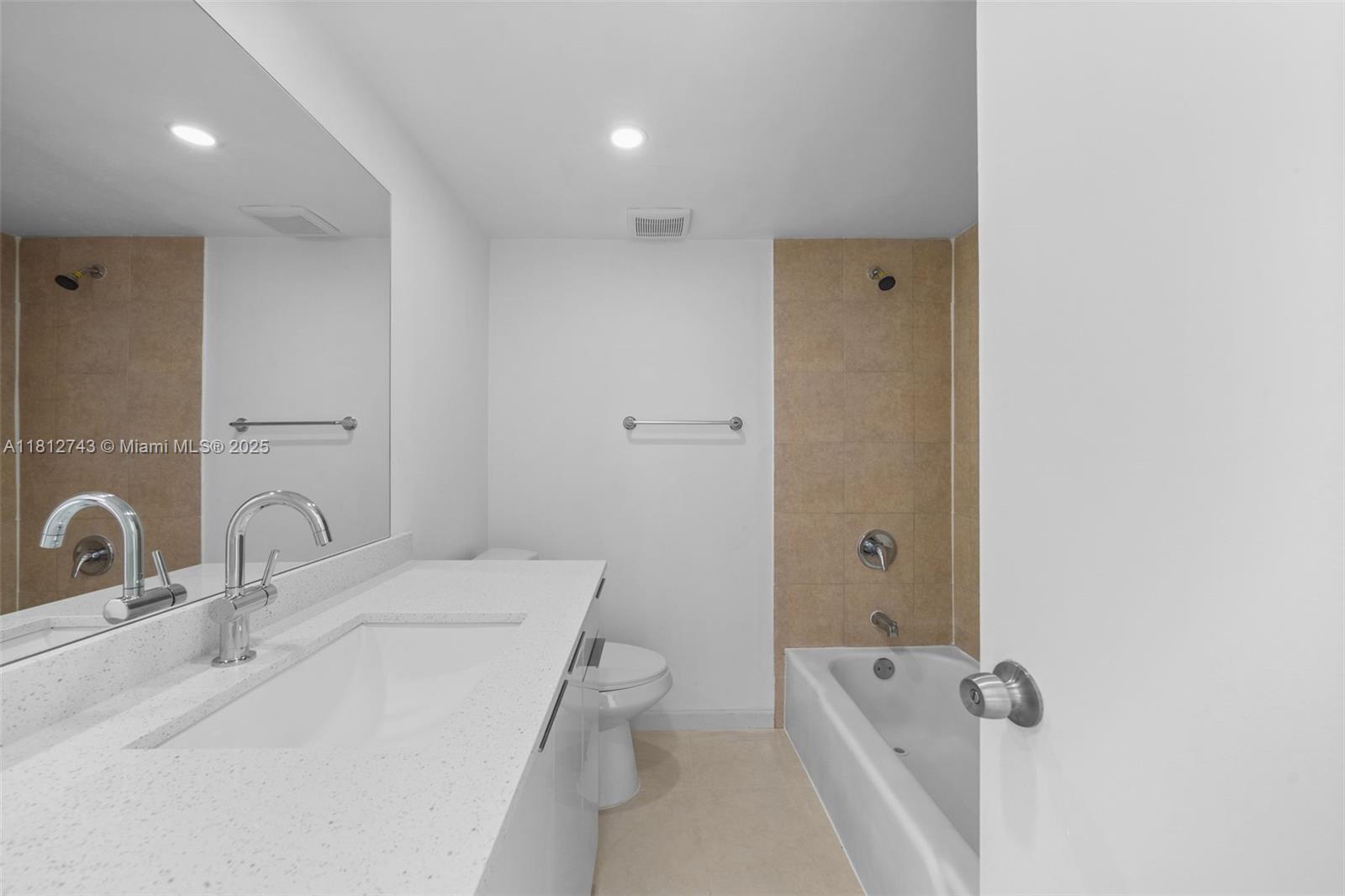 4222 Inverrary Boulevard, Unit 4211 Lauderhill, FL 33319 - Photo 10 of 18 a bathroom with a sink a toilet and shower