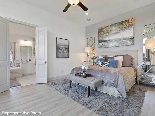 a bedroom with a bed and painting on the wall