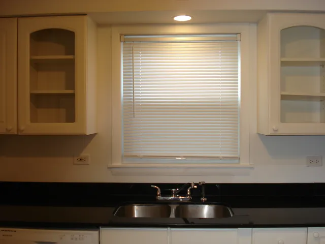 a kitchen with a refrigerator a sink and a window
