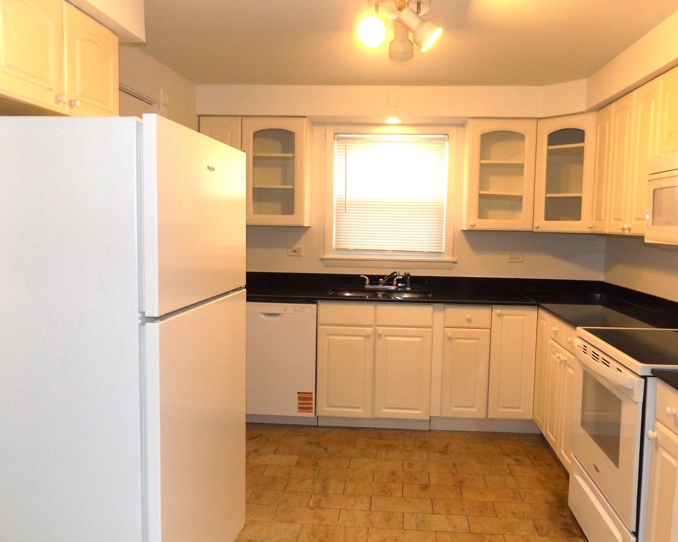 8751 West 79th Street, Unit 1 Justice, IL 60458 - Photo 19 of 32 a kitchen with a refrigerator a sink and a window
