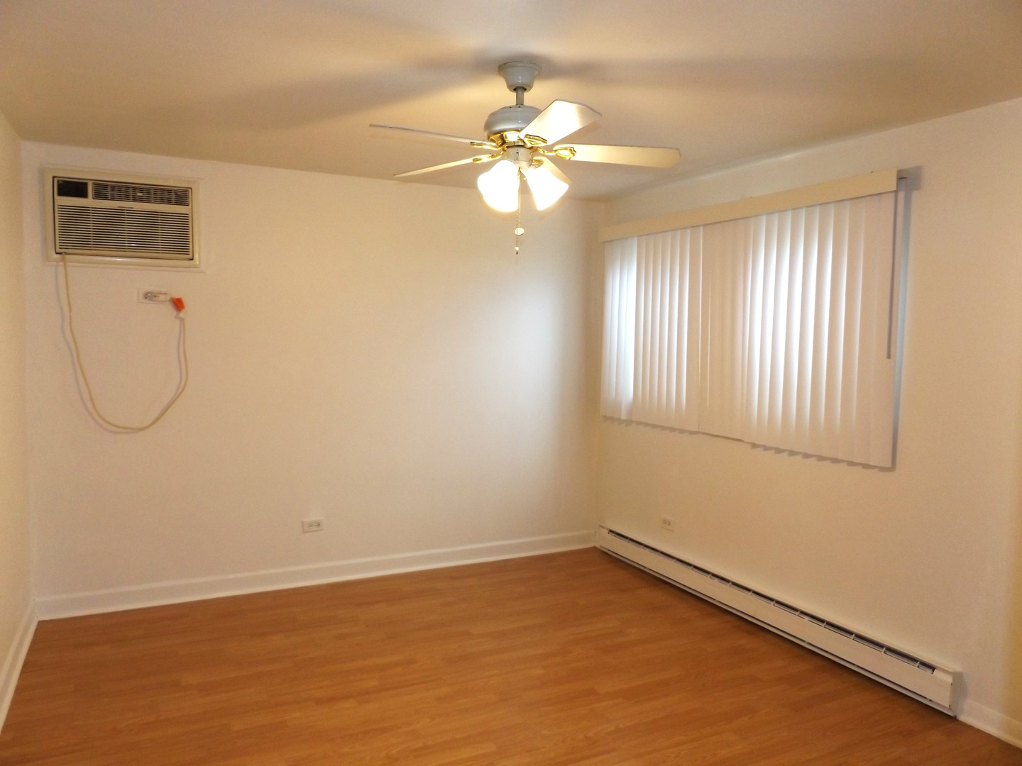8751 West 79th Street, Unit 1 Justice, IL 60458 - Photo 26 of 32 wooden floor in an empty room with a window