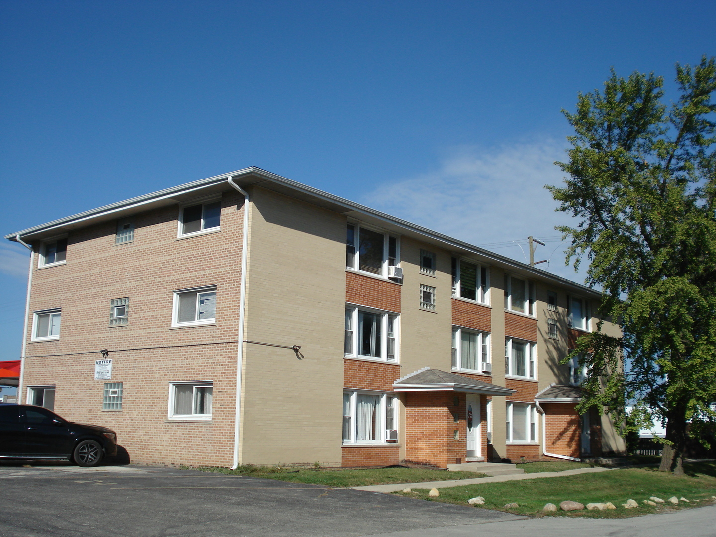 8751 West 79th Street, Unit 1 Justice, IL 60458 - Photo 3 of 32 a front view of a house with a yard
