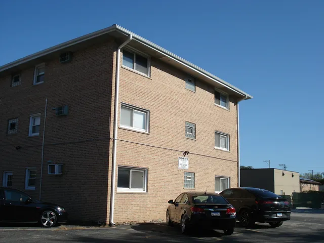 a car parked in front of a white house