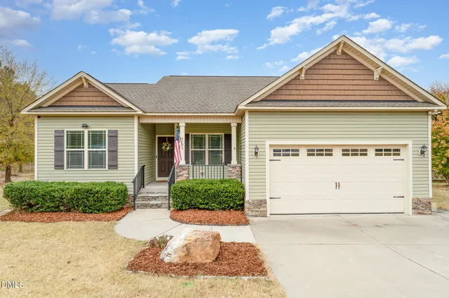a front view of a house with a yard and garage