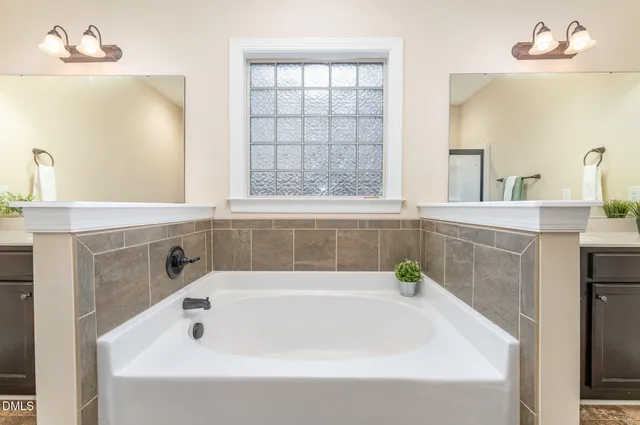 a white bath tub sitting next to a window