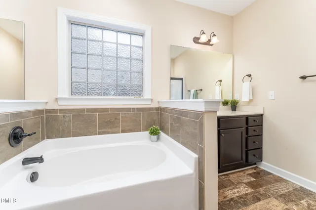 a bathroom with a bathtub and a sink