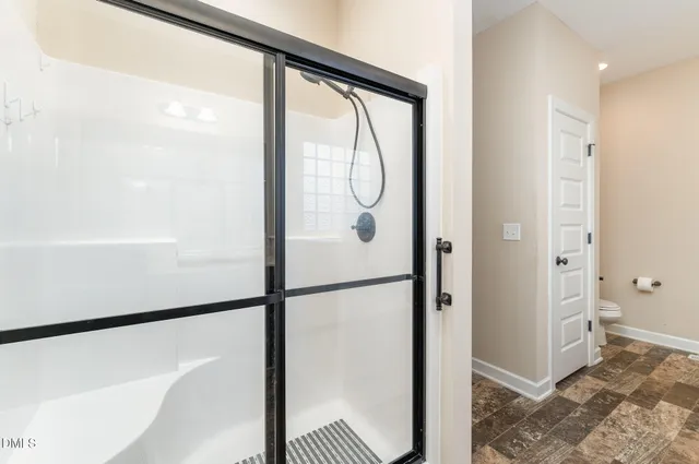 a bathroom with a glass shower door